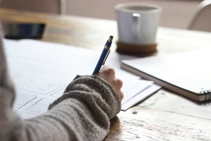 Student writing notes